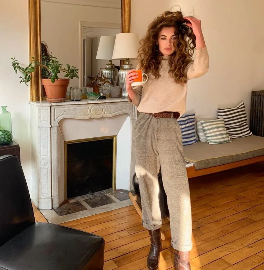 Woman in a beige turtleneck and tweed pants