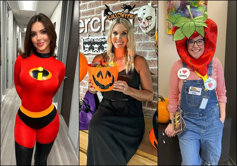 Three women in creative office Halloween costumes: the first dressed as Elastigirl from The Incredibles in a red superhero bodysuit, the second wearing a black dress with a Halloween headband holding a pumpkin candy bucket, and the third dressed as a strawberry in overalls with a large fruit headpiece and humorous GMO-themed badges.